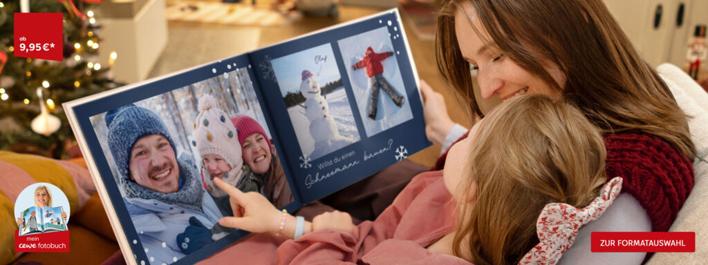 Eine Familie betrachtet gemeinsam ein CEWE FOTOBUCH mit winterlichen Erinnerungen.